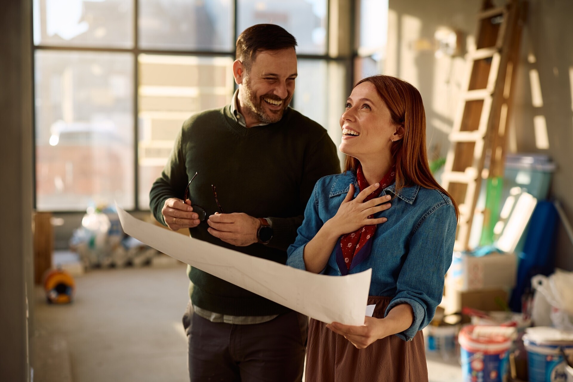 happy-couple-reviewing-blueprints-in-their-new-hom-2026-05-12-16-35-39-utc